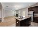 Open concept kitchen with an island and stainless steel appliances, open to living room at 1212 Ithaca Dr, Mcdonough, GA 30253