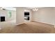 Open living area with neutral carpet, chandelier, and access to kitchen and living room spaces at 1212 Ithaca Dr, Mcdonough, GA 30253