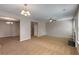 Spacious living room featuring neutral paint, carpet, and decorative lighting at 1212 Ithaca Dr, Mcdonough, GA 30253