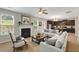 Cozy living room with fireplace, large windows, and comfortable seating open to the kitchen at 1212 Ithaca Dr, Mcdonough, GA 30253