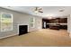 Sunlit living room with fireplace that is open to the kitchen at 1212 Ithaca Dr, Mcdonough, GA 30253
