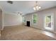Spacious living room with a fireplace, large windows, and a door leading to the outdoors at 1212 Ithaca Dr, Mcdonough, GA 30253