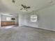 Spacious living room featuring carpet flooring, a ceiling fan and a kitchenette at 14367 Fincher Rd, Canton, GA 30114