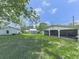 Wide shot of outbuildings including open-air garage and shed on property at 14367 Fincher Rd, Canton, GA 30114