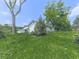 Spacious yard featuring green grass and mature trees, enhancing the property's curb appeal and natural beauty at 14367 Fincher Rd, Canton, GA 30114