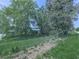 Fenced yard showing mature trees on a spacious lot with green grass and a ditch at 14367 Fincher Rd, Canton, GA 30114
