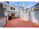 Picture of a backyard red deck showing a white house with a retractable awning at 1481 Bentley Se Ln, Marietta, GA 30067