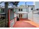 View of the backyard deck and exterior of the home with a retractable awning at 1481 Bentley Se Ln, Marietta, GA 30067