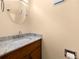 Elegant half-bath with granite countertop, modern faucet, and stylish round mirror at 1481 Bentley Se Ln, Marietta, GA 30067