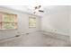 A spacious bedroom with ample light, neutral carpet and a ceiling fan at 1481 Bentley Se Ln, Marietta, GA 30067
