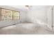 Bedroom with a ceiling fan, carpet flooring, and large windows at 1481 Bentley Se Ln, Marietta, GA 30067