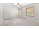Bright bedroom with neutral carpet, two windows, ceiling fan, and a closet at 1481 Bentley Se Ln, Marietta, GA 30067