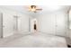 Bright bedroom featuring neutral carpet, fan, and access to an ensuite bathroom at 1481 Bentley Se Ln, Marietta, GA 30067