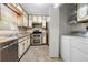 A well-lit kitchen with stainless steel appliances and a laundry area at 1481 Bentley Se Ln, Marietta, GA 30067