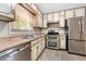 Charming kitchen featuring stainless steel appliances, double oven and a view from window at 1481 Bentley Se Ln, Marietta, GA 30067
