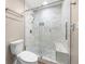 Bright bathroom with a glass shower door and tiled walls and floor at 1481 Bentley Se Ln, Marietta, GA 30067