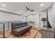Cozy basement featuring a modern futon, sleek TV, and a large dog crate at 722 Ivory Trl, Woodstock, GA 30188