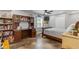 Well-lit room with a large built-in desk, ceiling fan, and bed with a view at 722 Ivory Trl, Woodstock, GA 30188