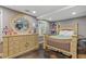 Comfortable bedroom with an elegant dresser with oval mirror and a well-lit window at 722 Ivory Trl, Woodstock, GA 30188