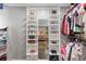 Walk-in closet featuring custom white built-in shelving for ample storage and organization at 722 Ivory Trl, Woodstock, GA 30188