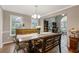 Bright dining room featuring wood floors, classic chandelier, and ample space for entertaining at 722 Ivory Trl, Woodstock, GA 30188