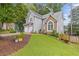 Beautiful home featuring stone accents, manicured lawn, and a charming, inviting entrance at 722 Ivory Trl, Woodstock, GA 30188