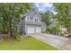 Charming two-story home with a two-car garage and well-manicured lawn in a lush, wooded setting at 722 Ivory Trl, Woodstock, GA 30188