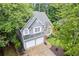 Aerial view of home featuring a two-car garage, front yard, and well-manicured landscaping at 722 Ivory Trl, Woodstock, GA 30188