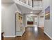 Spacious foyer with hardwood floors, coat rack, and view of the living spaces at 722 Ivory Trl, Woodstock, GA 30188