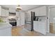 Bright kitchen features white cabinets, stainless appliances and lots of counter space at 722 Ivory Trl, Woodstock, GA 30188