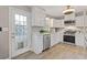 Updated kitchen with white cabinets, stainless appliances, and a door to the outside deck at 722 Ivory Trl, Woodstock, GA 30188