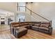 Comfortable living room with a tall staircase, leather couch and open kitchen at 722 Ivory Trl, Woodstock, GA 30188