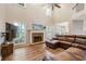 Inviting living room with stone fireplace, lots of light and comfortable leather furniture at 722 Ivory Trl, Woodstock, GA 30188