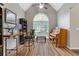 Home office featuring large window, wood floors, bookshelves, and comfortable workspace at 722 Ivory Trl, Woodstock, GA 30188