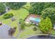 Aerial view of community pool with lounge chairs surrounded by lush landscaping and nearby gazebo at 722 Ivory Trl, Woodstock, GA 30188