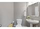 Clean powder room with pedestal sink, neutral colors, and a well-lit vanity mirror at 722 Ivory Trl, Woodstock, GA 30188