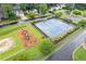Tennis and play area featuring a playground and well-maintained tennis courts with blue surfaces at 722 Ivory Trl, Woodstock, GA 30188