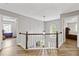 Upstairs landing with view of the entryway and bedroom on either side at 722 Ivory Trl, Woodstock, GA 30188