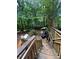 Multi-tiered wooden back deck nestled in a wooded backyard, perfect for outdoor enjoyment and relaxation at 974 Bloomfield Dr, Lawrenceville, GA 30044