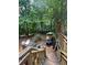 Wooden backyard deck surrounded by lush greenery, offering a private and serene outdoor space with nature at 974 Bloomfield Dr, Lawrenceville, GA 30044