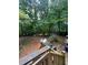 Spacious wooded backyard with tiered wooden deck, great for outdoor gatherings and enjoying nature at 974 Bloomfield Dr, Lawrenceville, GA 30044