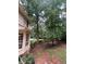 Lush backyard with mature trees and a wooden fence, creating a private outdoor space at 974 Bloomfield Dr, Lawrenceville, GA 30044