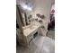 This bathroom features patterned tile flooring, a white vanity with lots of storage, and an organized closet at 974 Bloomfield Dr, Lawrenceville, GA 30044