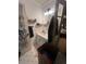 Modest bathroom featuring a single vanity, overhead lighting, and black and white patterned floor at 974 Bloomfield Dr, Lawrenceville, GA 30044