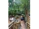 Expansive wooden deck surrounded by lush greenery, perfect for outdoor relaxation and entertaining at 974 Bloomfield Dr, Lawrenceville, GA 30044