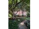 Attractive brick home with mature trees, walkway, and traditional architectural details at 974 Bloomfield Dr, Lawrenceville, GA 30044