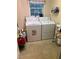 Practical laundry room equipped with washer, dryer, and storage shelves at 974 Bloomfield Dr, Lawrenceville, GA 30044