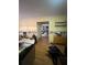 Messy living room with hardwood floors, black trashbags, and yellow walls, cluttered with items at 974 Bloomfield Dr, Lawrenceville, GA 30044