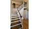 Elegant staircase with dark wood treads and white risers leads to the upper level, bathed in natural light at 974 Bloomfield Dr, Lawrenceville, GA 30044