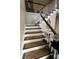 Carpeted staircase with white railings and a dark wood banister at 974 Bloomfield Dr, Lawrenceville, GA 30044